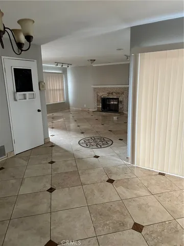 an empty room with a fireplace and windows