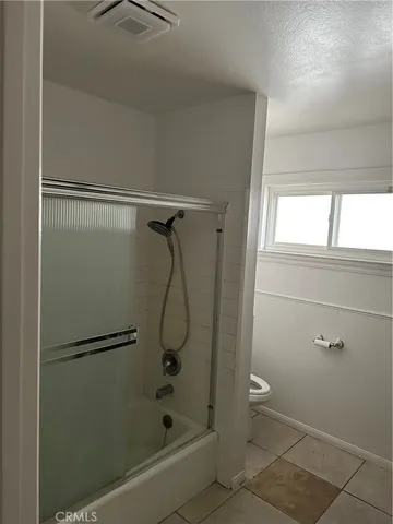 a bathroom with a glass shower door