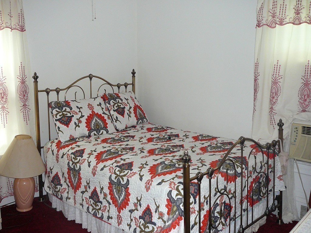40 Revere Street Springfield, MA 01108 - Photo 10 of 21 a bed sitting in a bedroom next to a lamp