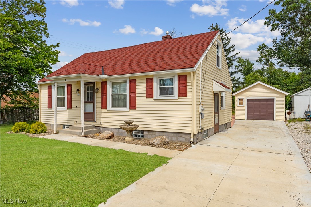 61 Ledge Road Northfield, OH 44067 - Photo 4 of 23 View of front facade with a garage, a front yard, and an outbuilding