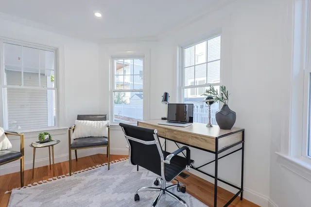 a view of a workspace with furniture and a window