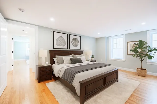a bedroom with bed and a potted plant