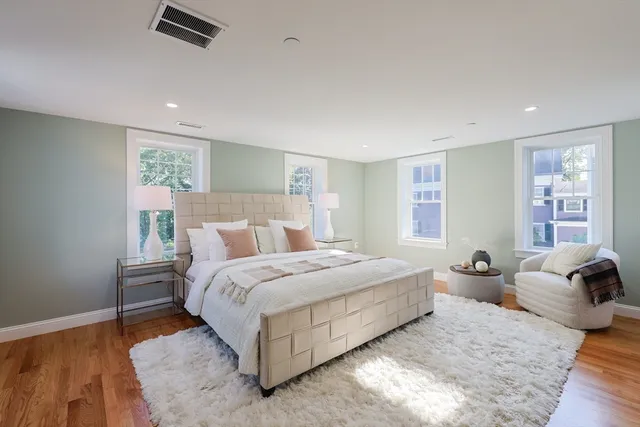 a bed room with a bed and wooden floor