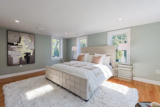 a bedroom with a large bed and a window