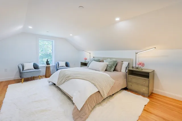 a bedroom with bed and window