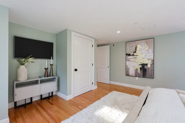 a bedroom with a bed and a flat screen tv