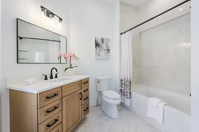 a bathroom with a toilet a sink and a bathtub