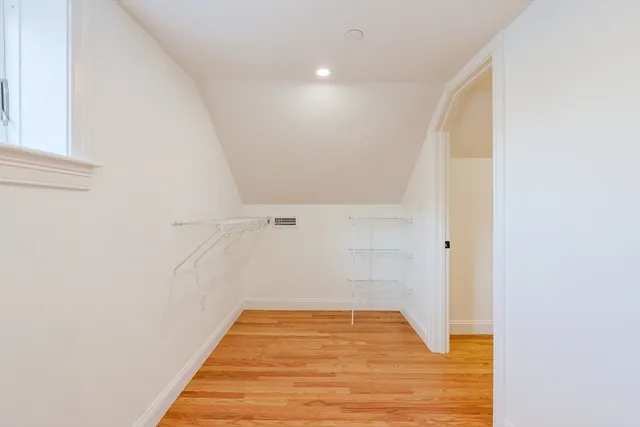 a view of a room with wooden floor and white walls