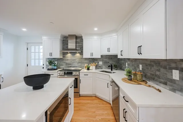a kitchen with a sink a stove and cabinets