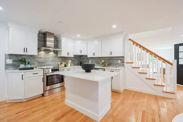 a kitchen with white cabinets and white appliances