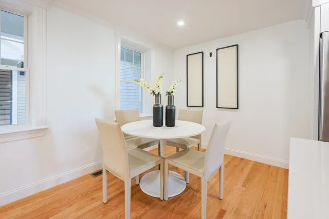 a dining room with furniture and wooden floor