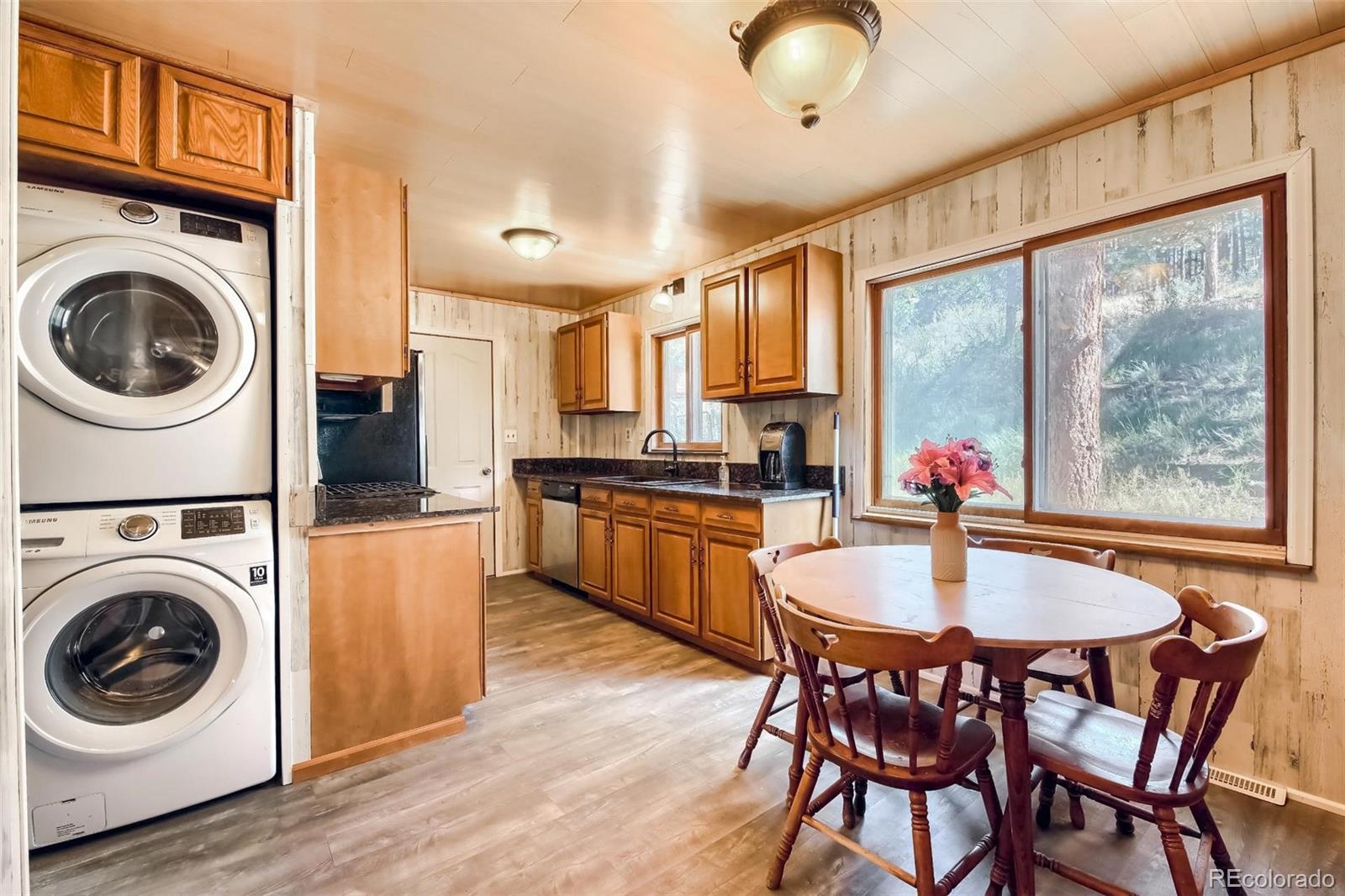 145 Bailey Drive Bailey, CO 80421 - Photo 11 of 40 a kitchen with a table chairs sink and cabinets
