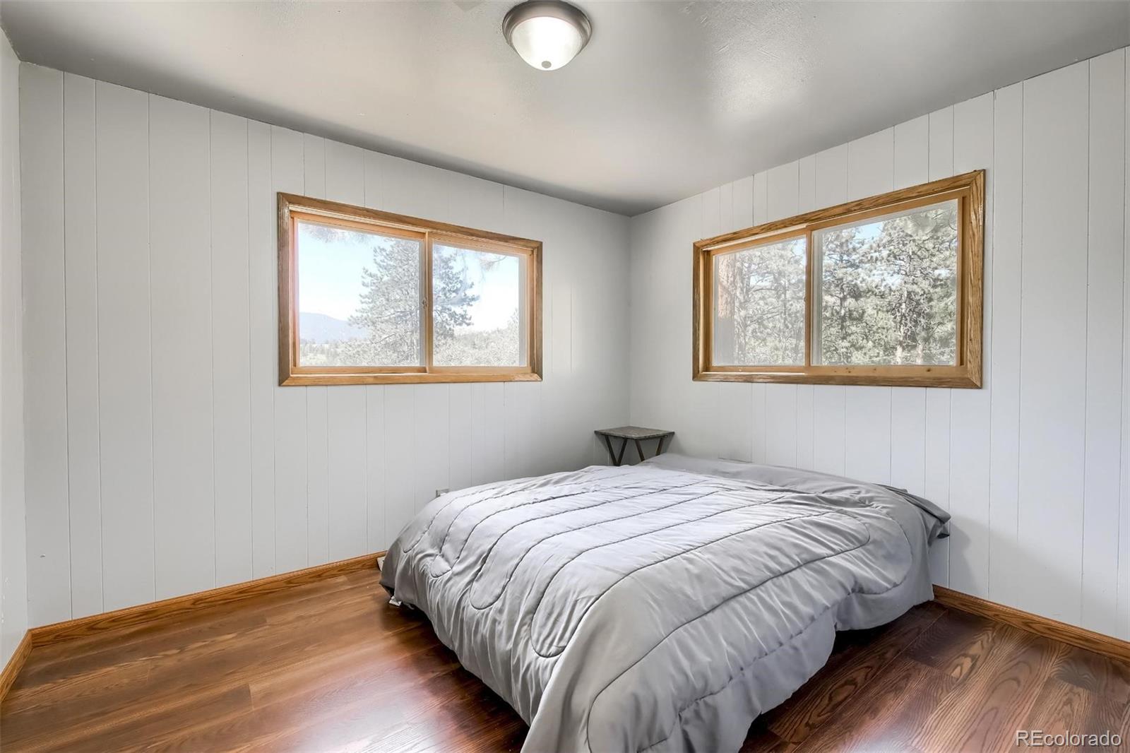 145 Bailey Drive Bailey, CO 80421 - Photo 15 of 40 a bedroom with bed and a window