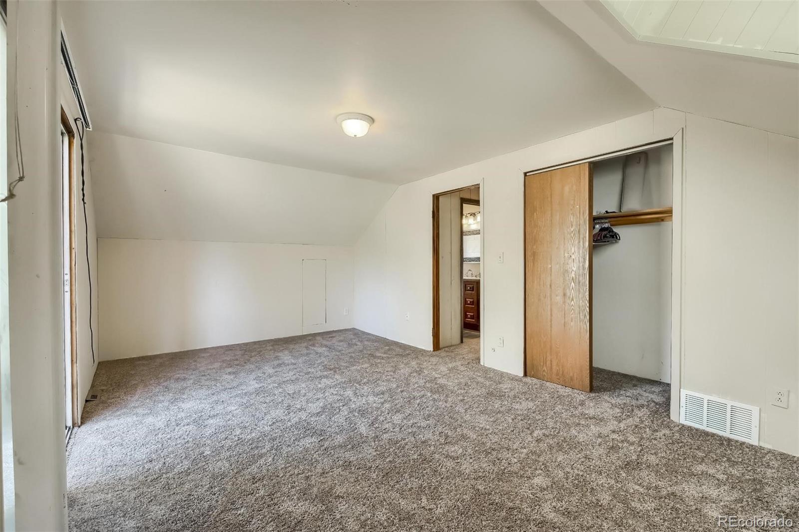 145 Bailey Drive Bailey, CO 80421 - Photo 22 of 40 an empty room with closet and a hallway
