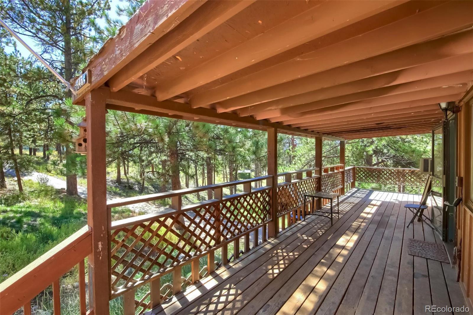 145 Bailey Drive Bailey, CO 80421 - Photo 30 of 40 a view of a balcony with wooden floor
