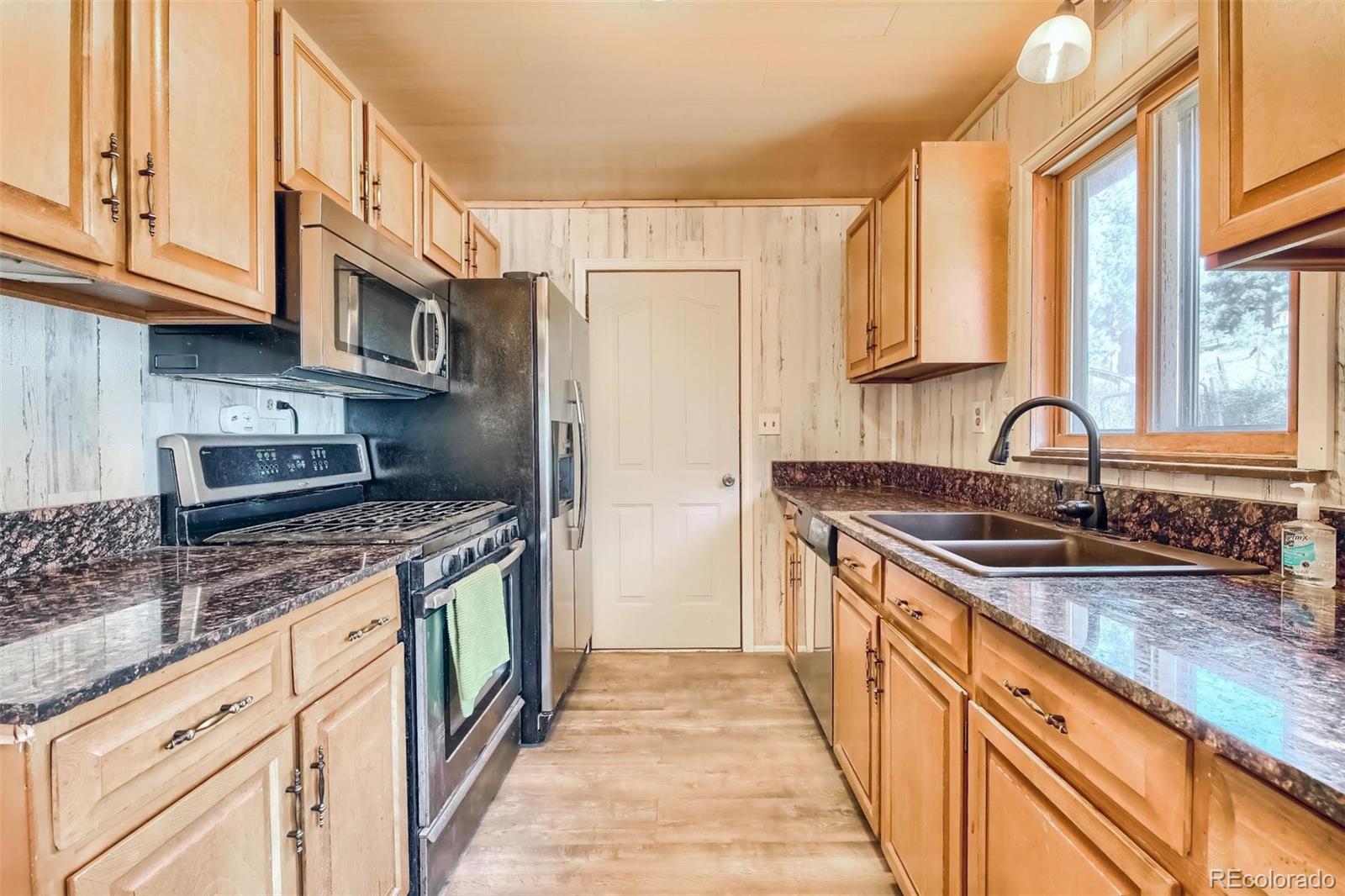 145 Bailey Drive Bailey, CO 80421 - Photo 6 of 40 a kitchen with stainless steel appliances granite countertop a sink stove and refrigerator