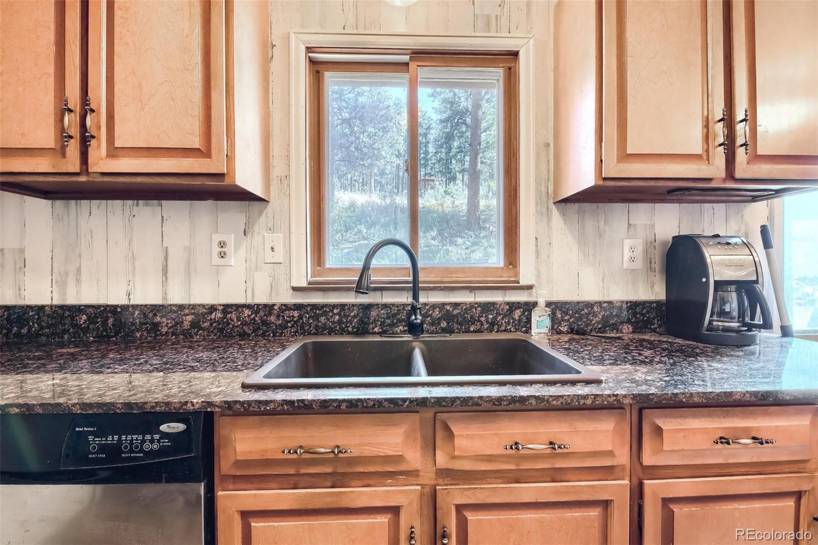 145 Bailey Drive Bailey, CO 80421 - Photo 7 of 40 a kitchen with granite countertop a sink and a window