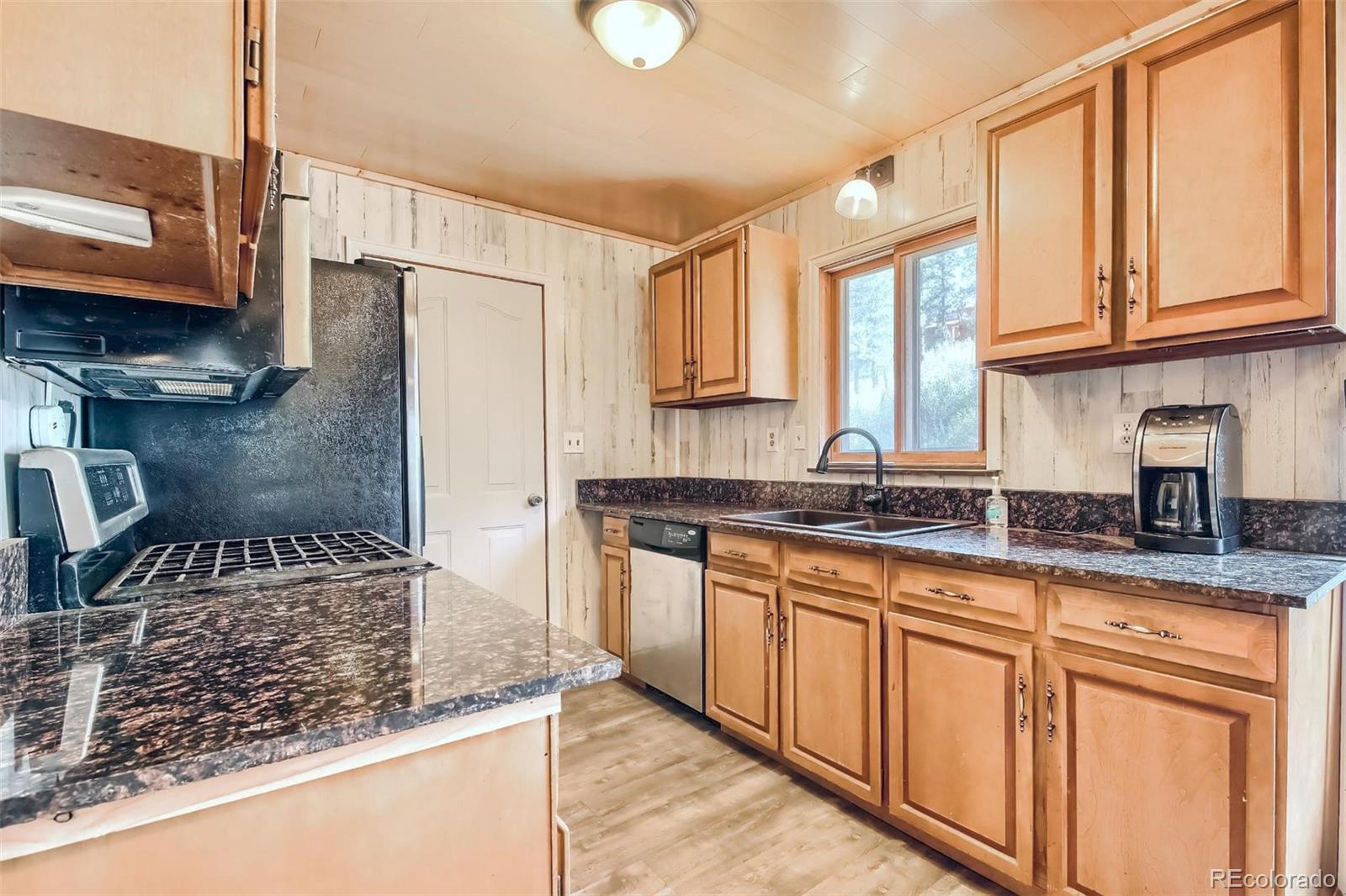 145 Bailey Drive Bailey, CO 80421 - Photo 8 of 40 a kitchen with stainless steel appliances granite countertop a sink stove and cabinets