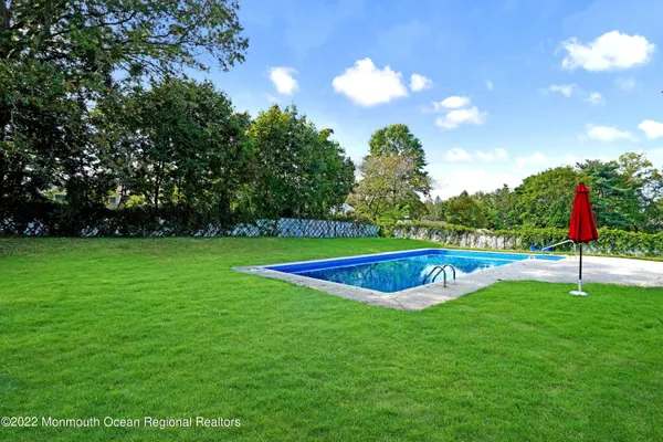 a view of a swimming pool with a yard