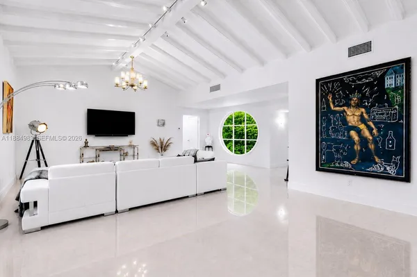 a living room with furniture and a flat screen tv
