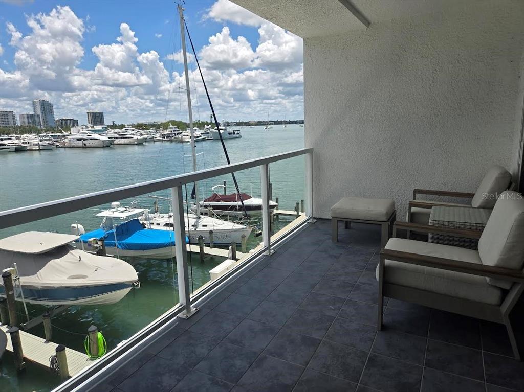 650 Golden Gate Point, Unit 301 Sarasota, FL 34236 - Photo 30 of 31 a view of a couches and table in the balcony