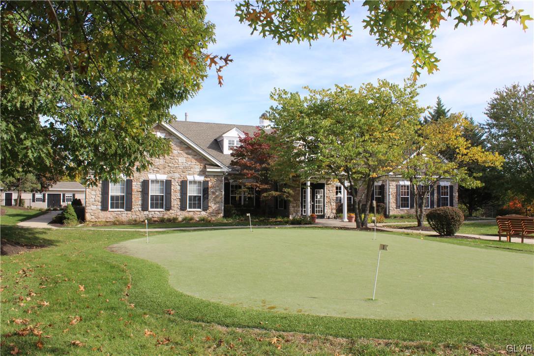 1888 Gregory Place Hellertown, PA 18055 - Photo 26 of 33 a front view of a building with a garden and trees