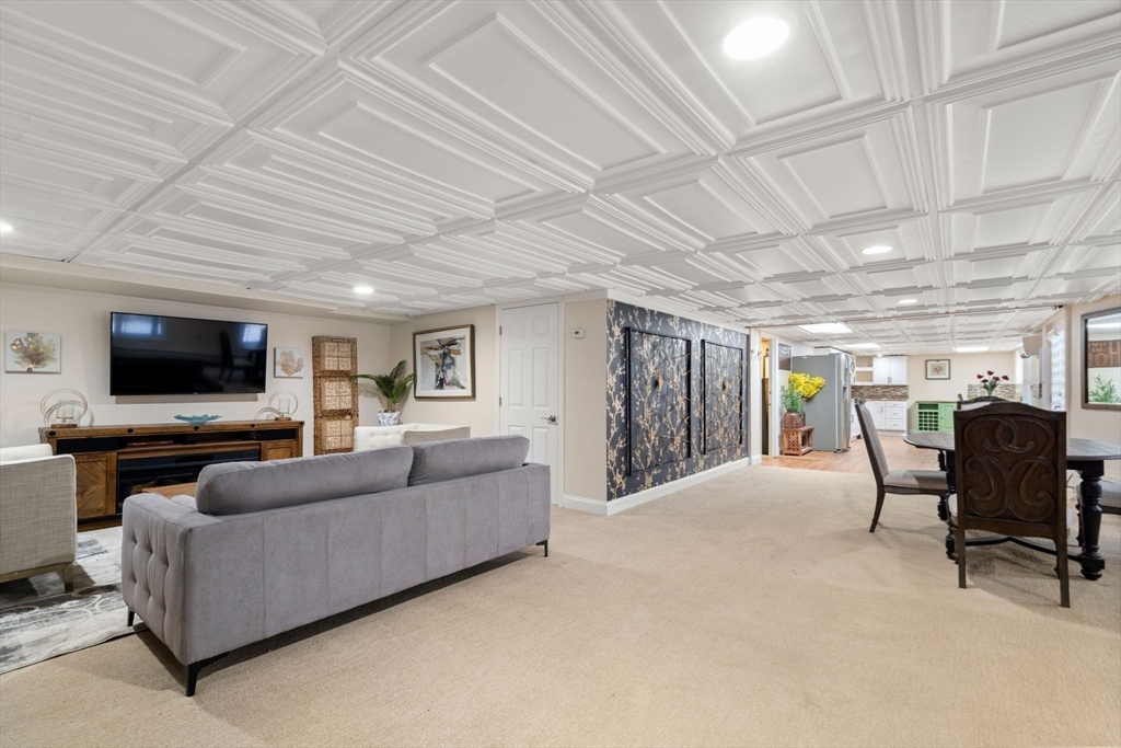 242 Boston Road Sutton, MA 01590 - Photo 25 of 39 a living room with furniture and a flat screen tv