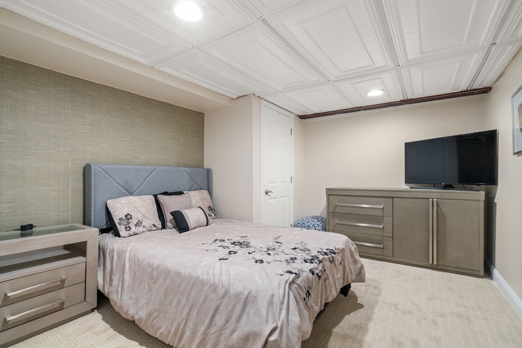 242 Boston Road Sutton, MA 01590 - Photo 28 of 39 a bedroom with a bed and a flat screen tv