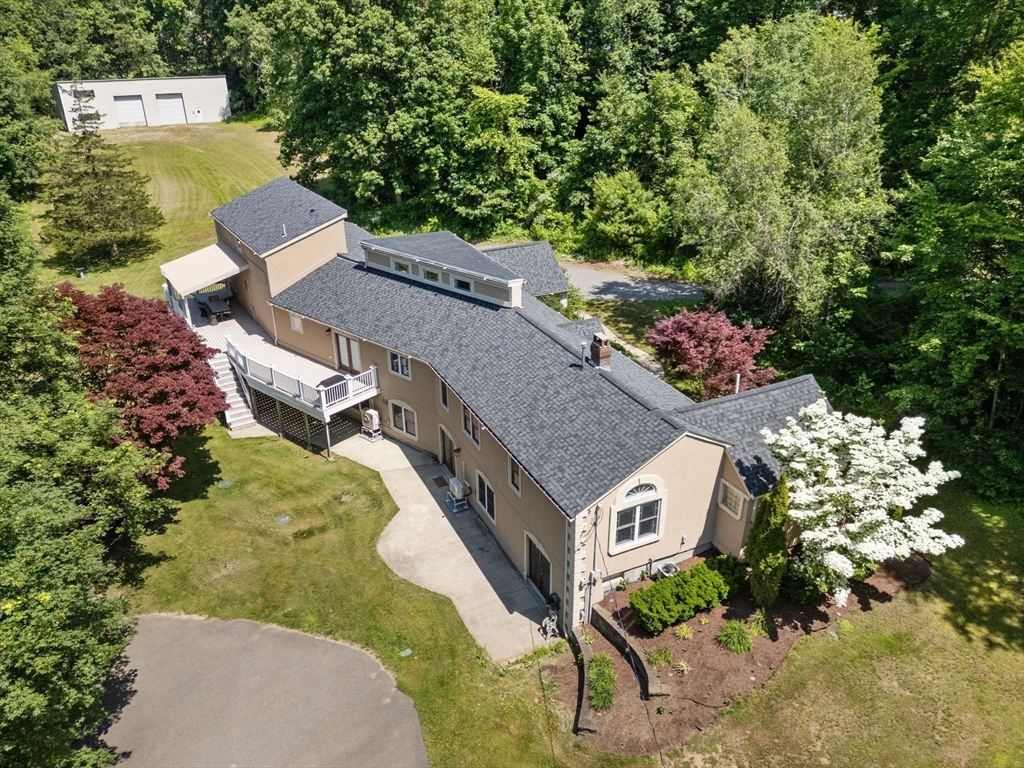 242 Boston Road Sutton, MA 01590 - Photo 31 of 39 an aerial view of a house with a yard and trees