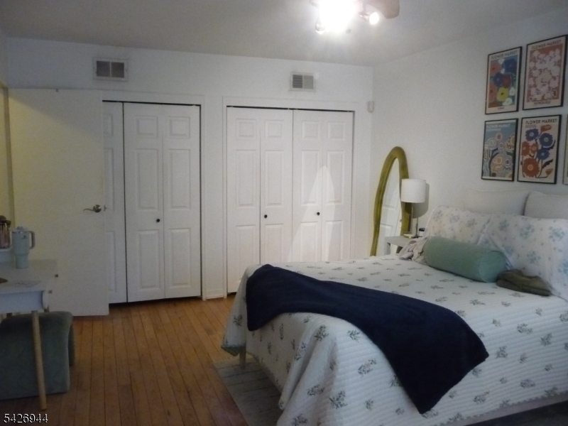 29 Up Mountain Avenue, Unit 2 Montclair, NJ 07042 - Photo 11 of 15 a bedroom with a bed and a painting on the wall