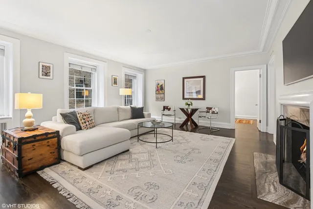 a living room with fireplace furniture and a flat screen tv
