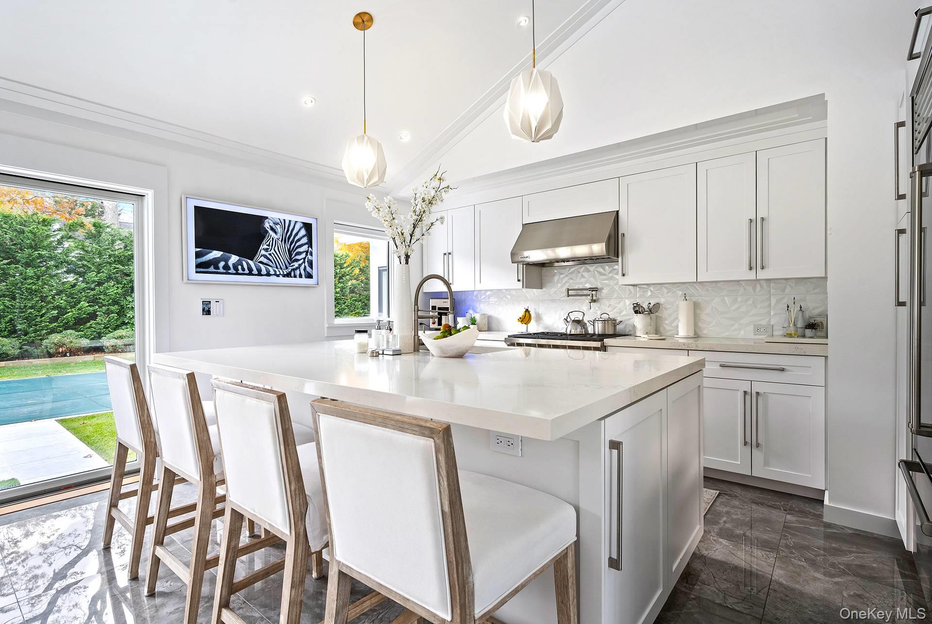 54 Glade Road East Hampton, NY 11937 - Photo 11 of 35 a kitchen with stainless steel appliances granite countertop a stove a sink island and a refrigerator