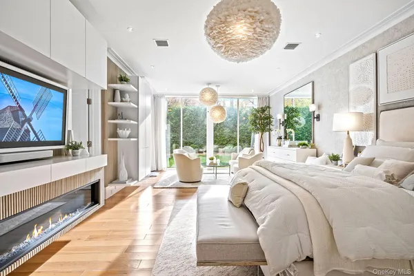 a spacious bedroom with a bed and a large window