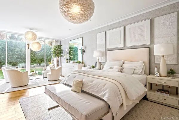 a bedroom with a large bed and a large window