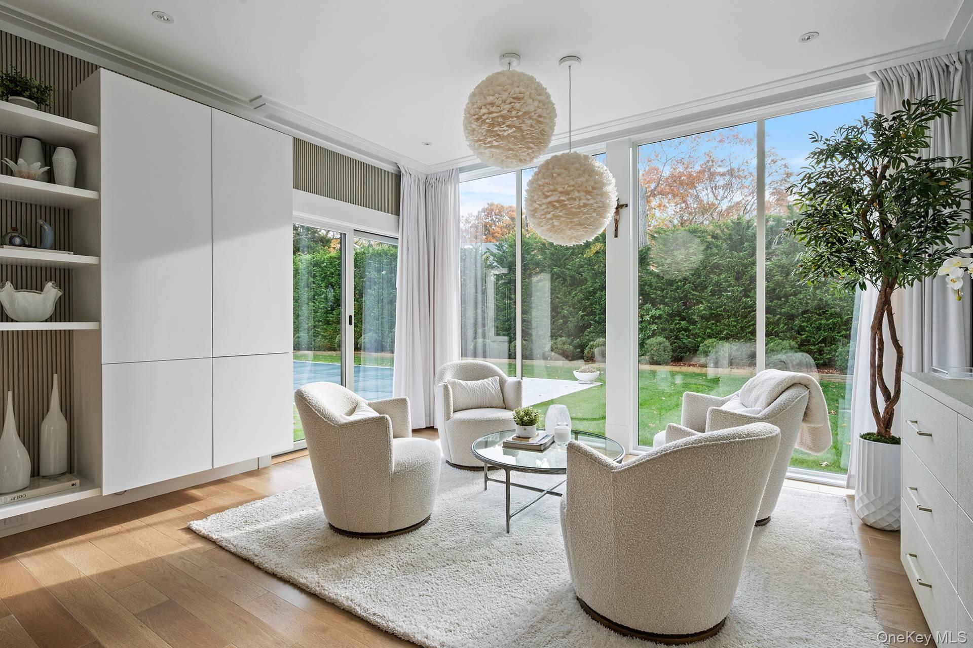 54 Glade Road East Hampton, NY 11937 - Photo 14 of 35 a living room with furniture and a large window