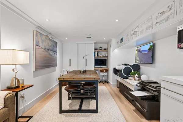 a room with furniture a flat screen tv and a window