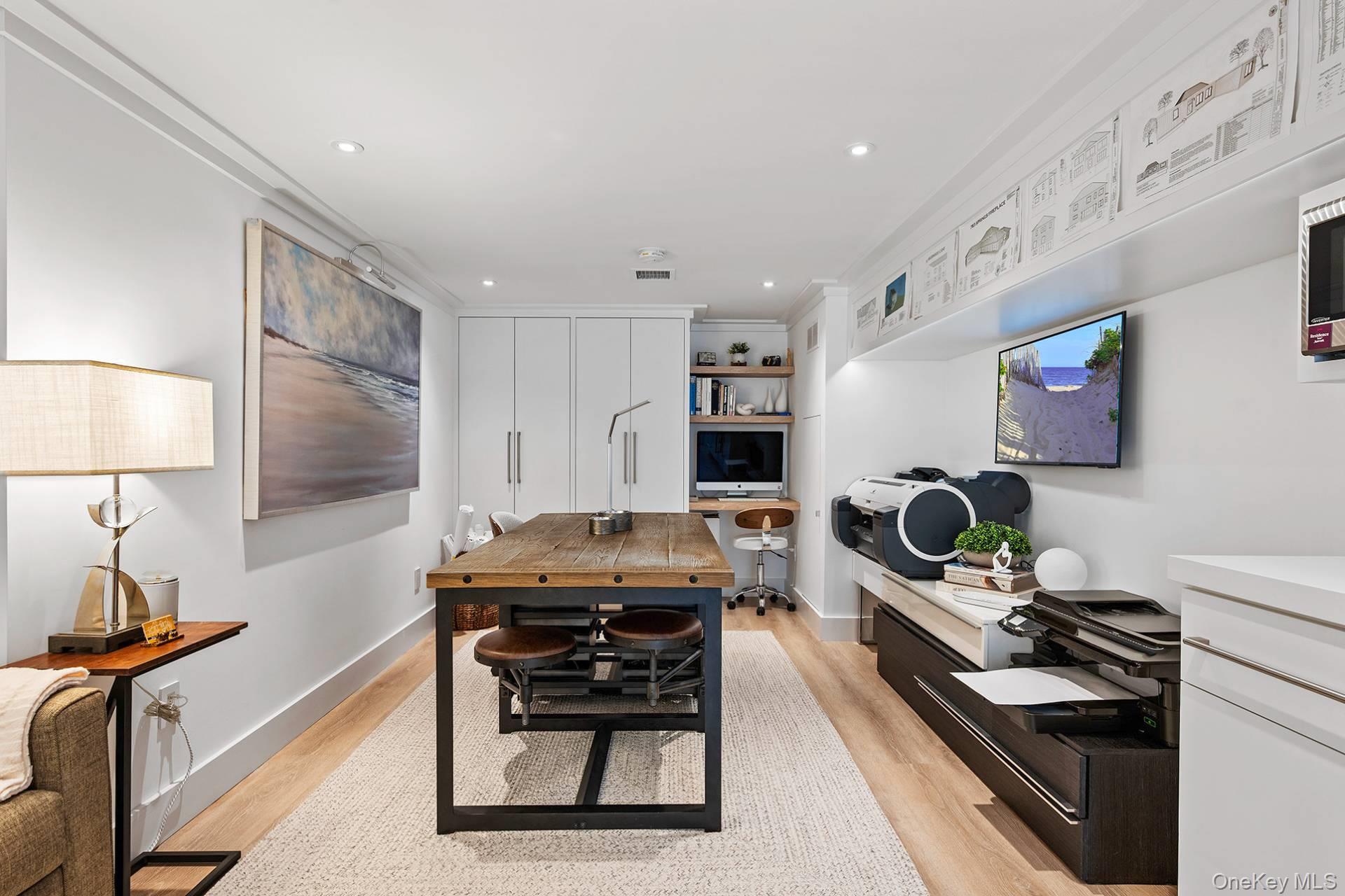 54 Glade Road East Hampton, NY 11937 - Photo 22 of 35 a room with furniture a flat screen tv and a window