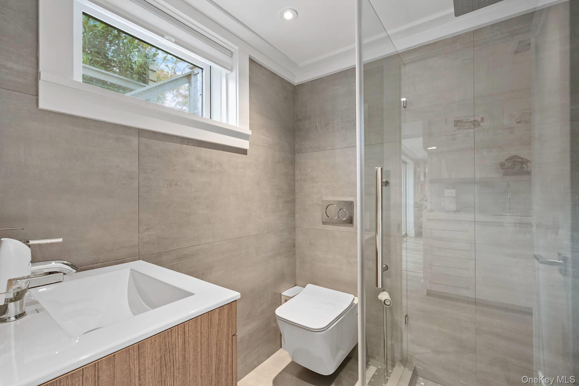 54 Glade Road East Hampton, NY 11937 - Photo 24 of 35 a bathroom with a toilet sink and shower