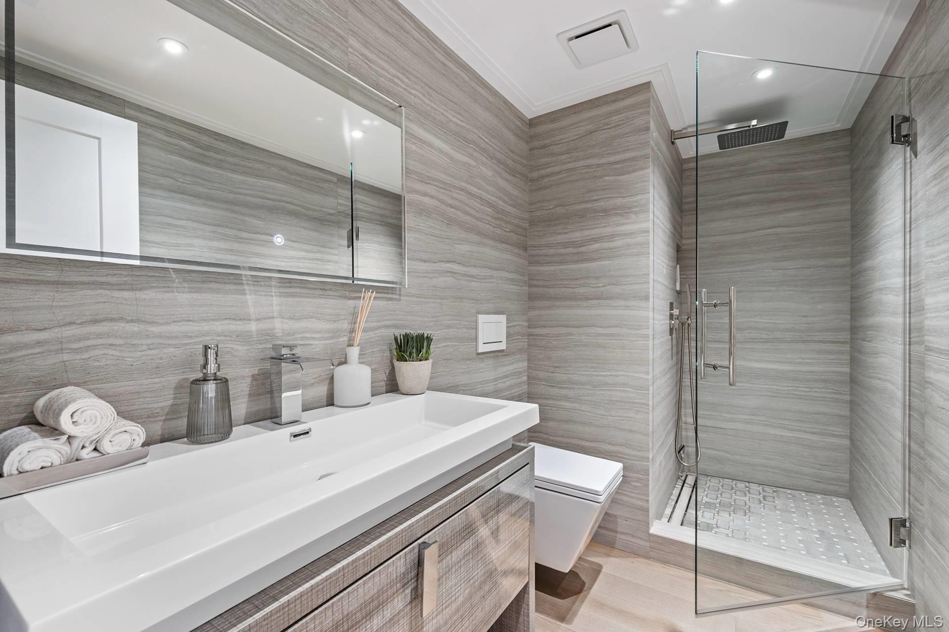 54 Glade Road East Hampton, NY 11937 - Photo 26 of 35 a bathroom with a sink a toilet and shower