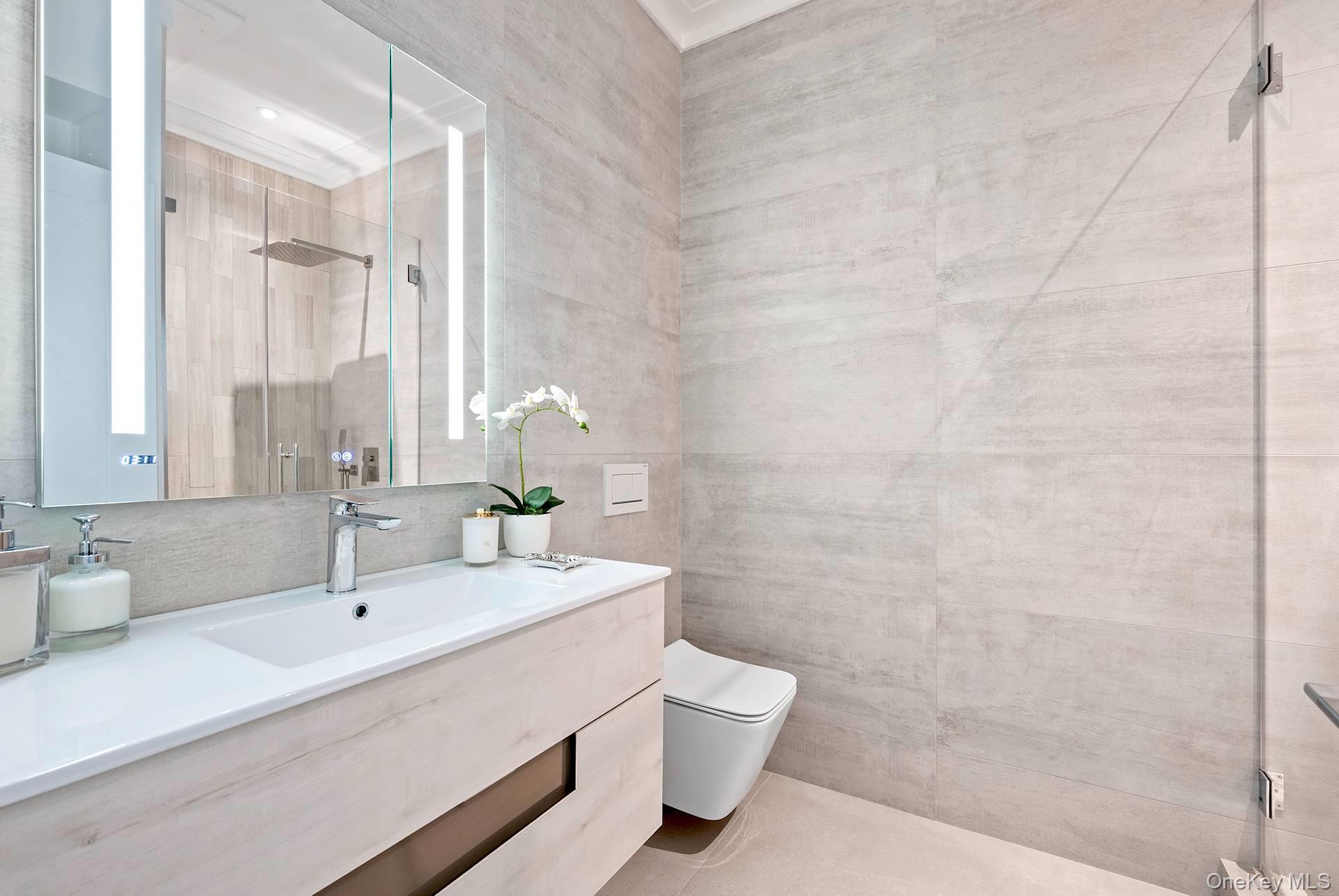 54 Glade Road East Hampton, NY 11937 - Photo 29 of 35 a bathroom with a sink a toilet and shower