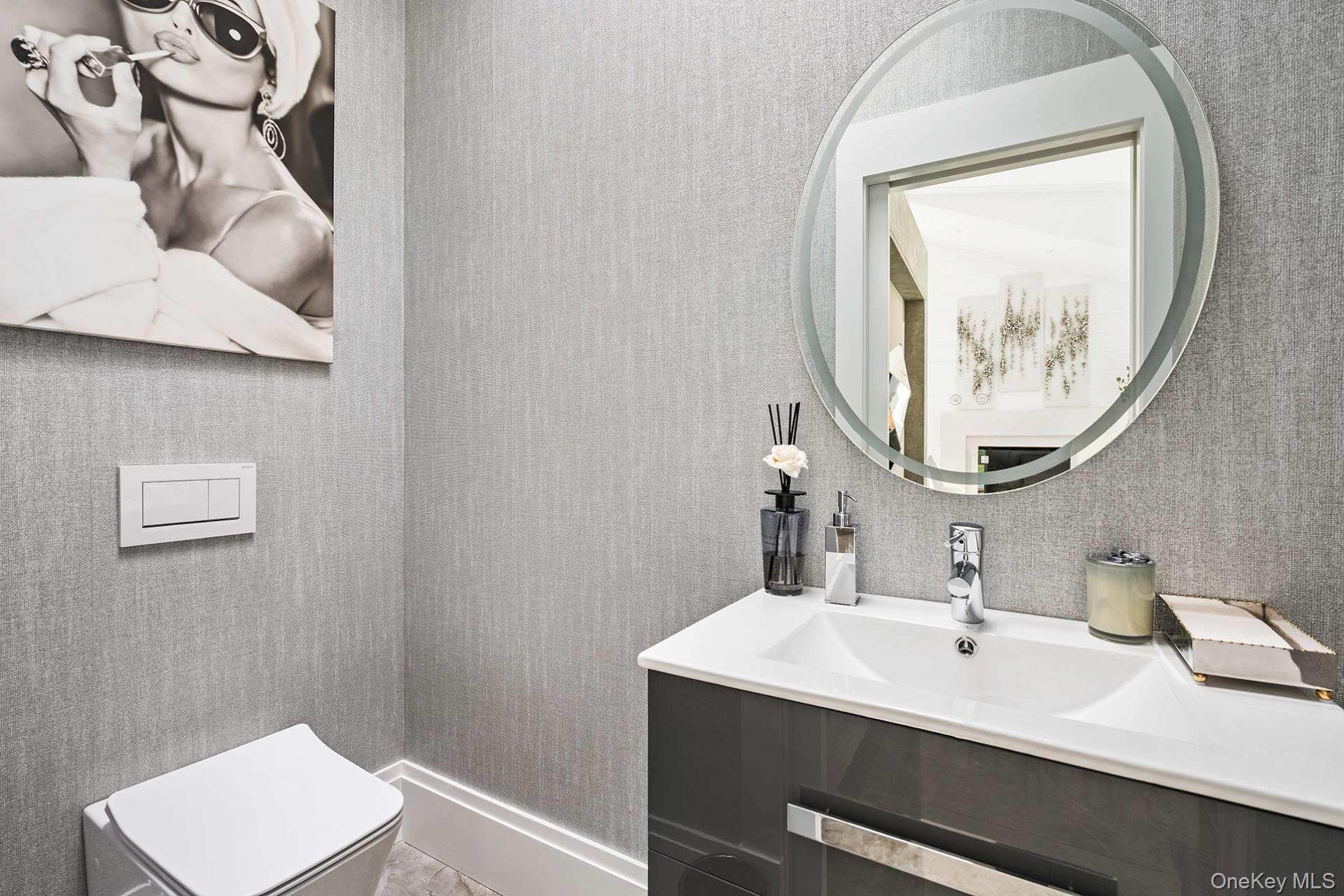 54 Glade Road East Hampton, NY 11937 - Photo 31 of 35 a bathroom with a sink and a mirror