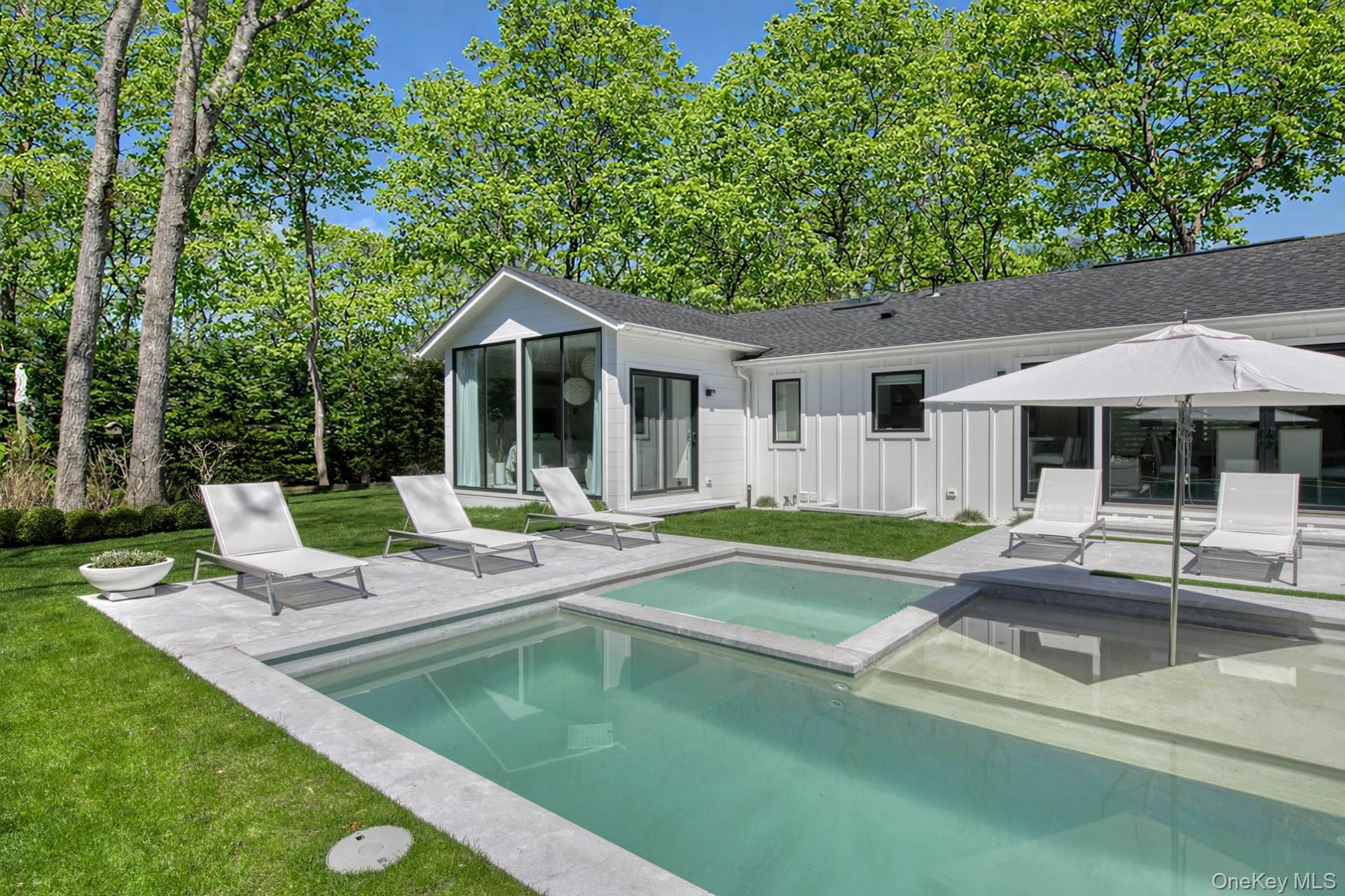 54 Glade Road East Hampton, NY 11937 - Photo 33 of 35 a view of a house with backyard patio and swimming pool