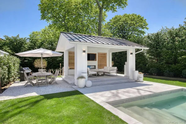 a view of a house with backyard sitting area and garden
