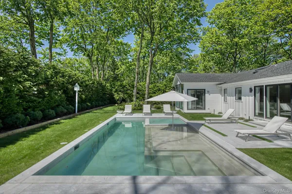 a view of a house with backyard and sitting area