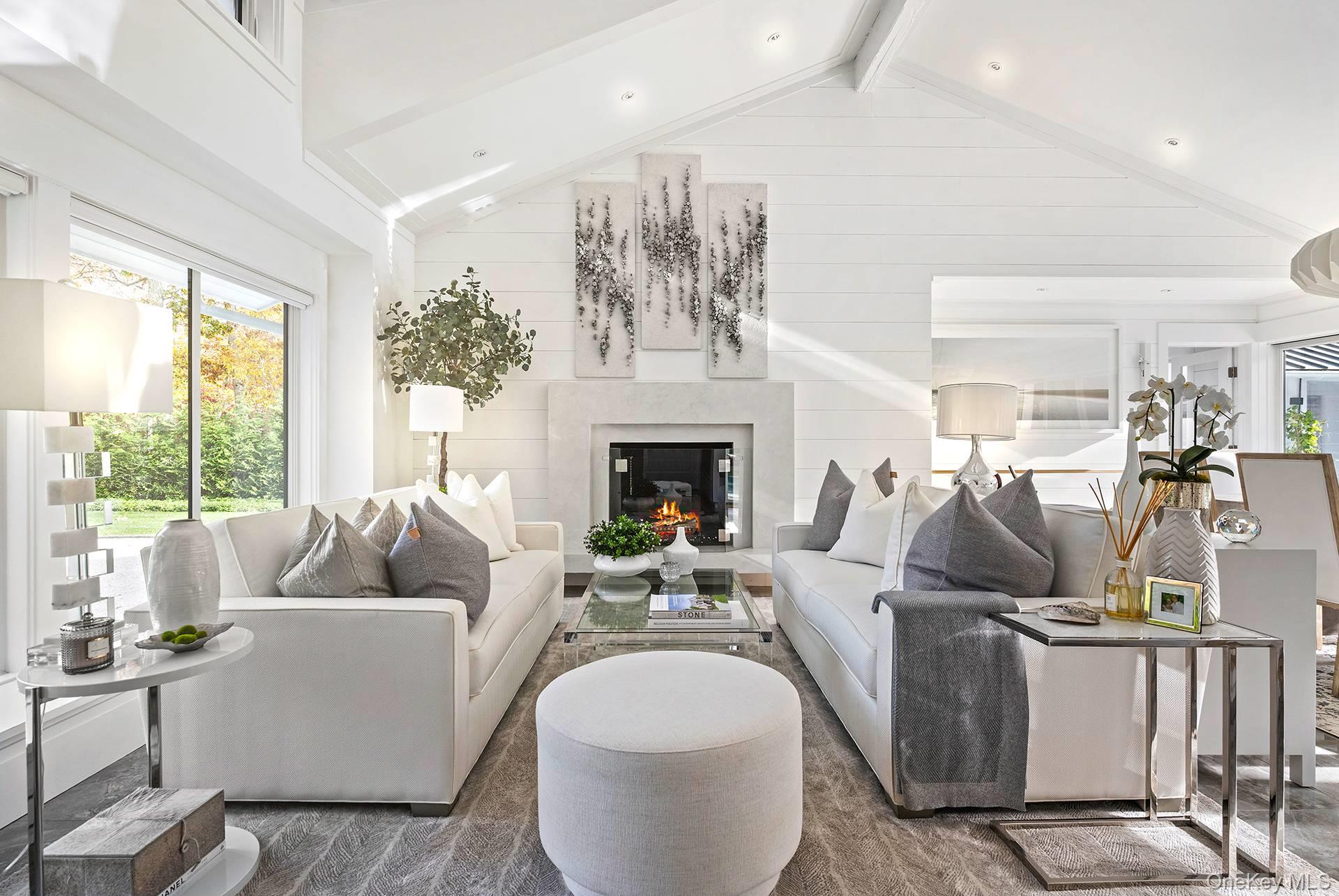 54 Glade Road East Hampton, NY 11937 - Photo 6 of 35 a living room with furniture a fireplace and a chandelier