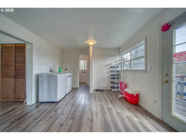 a open hall with cabinets and wooden floor