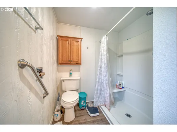 a bathroom with a toilet and a shower