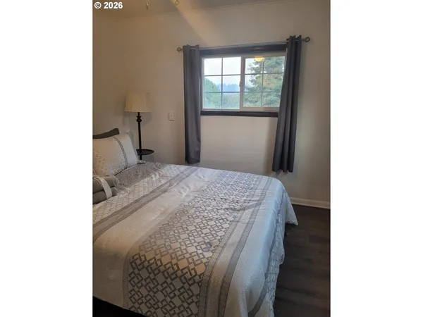 a bedroom with a bed and a window