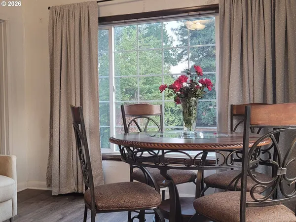 a dining room with furniture and wooden floor