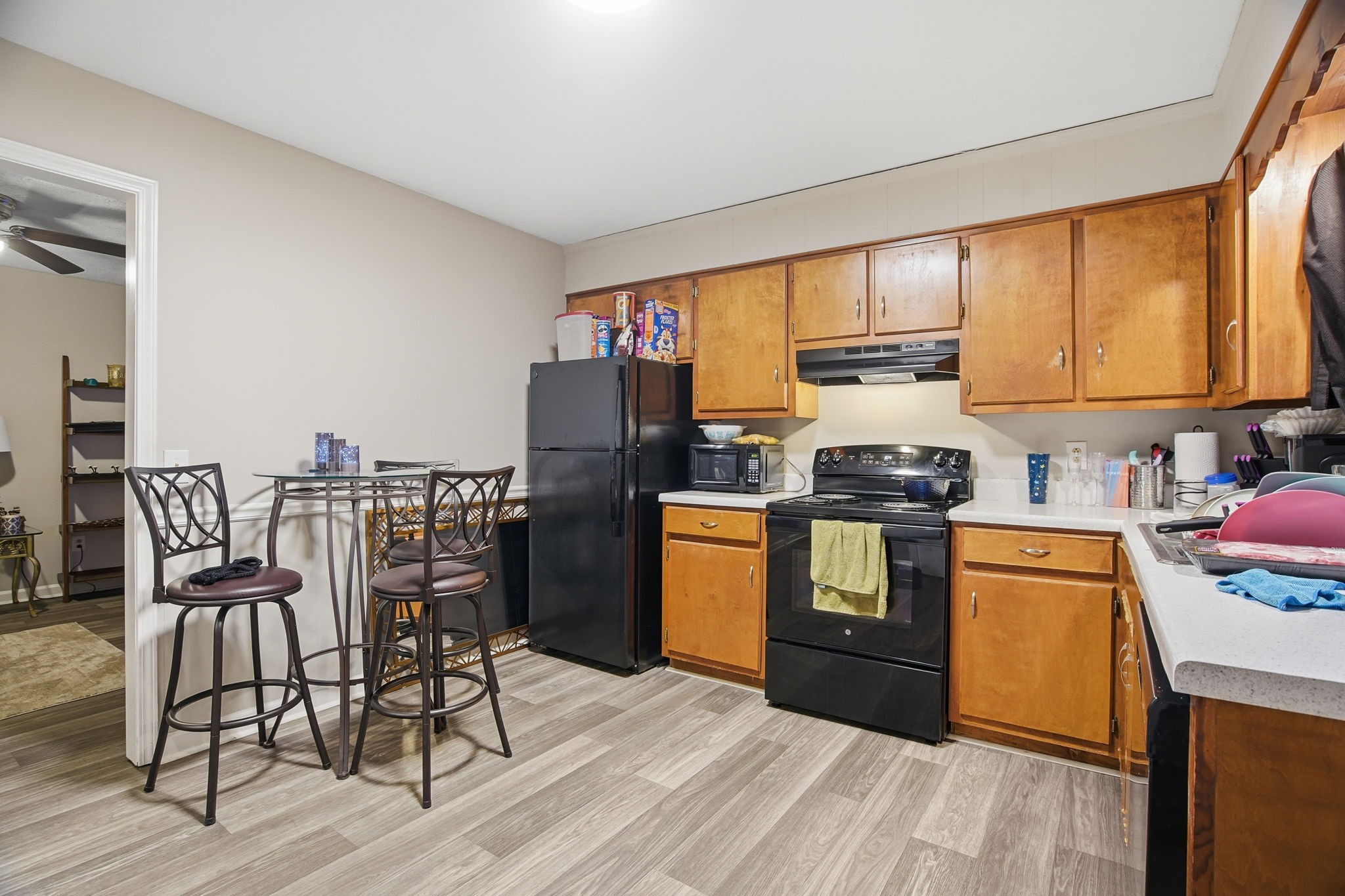 115 Gayla Court Portland, TN 37148 - Photo 35 of 46 a kitchen with granite countertop a refrigerator a stove top oven and a dining table